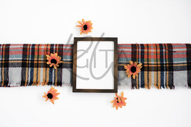 Vertical rustic wood sign displayed on a fall blanket surrounded by sunflowers. 
